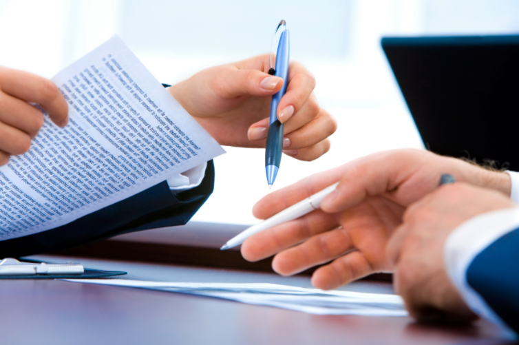 Two people reviewing legal documents.